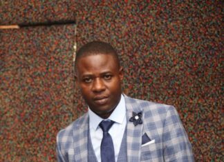 Dr Paul Shambare holds a business award he received recently