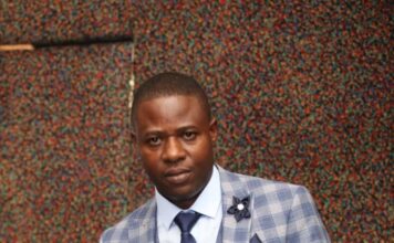 Dr Paul Shambare holds a business award he received recently