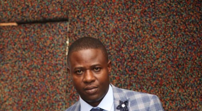 Dr Paul Shambare holds a business award he received recently