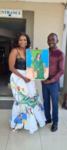 Ralph Jamu with socialite Zodwa Mkandla after handing over a painting to the businesswoman