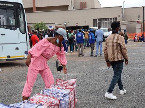 Some of the more than 200,000 Zimbabwean returnees over the past year receive post-arrival assistance while awaiting transportation to different parts of the country © IOM