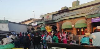 Vendors and other residents from Karoi mingle in front of the building that was gutted in yet another fire incident in Karoi. Mashonaland West has recorded an increased number of fire incidents during this year's fire season