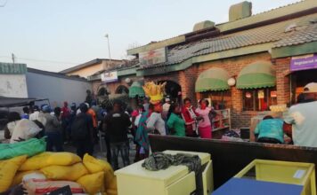 Vendors and other residents from Karoi mingle in front of the building that was gutted in yet another fire incident in Karoi. Mashonaland West has recorded an increased number of fire incidents during this year's fire season